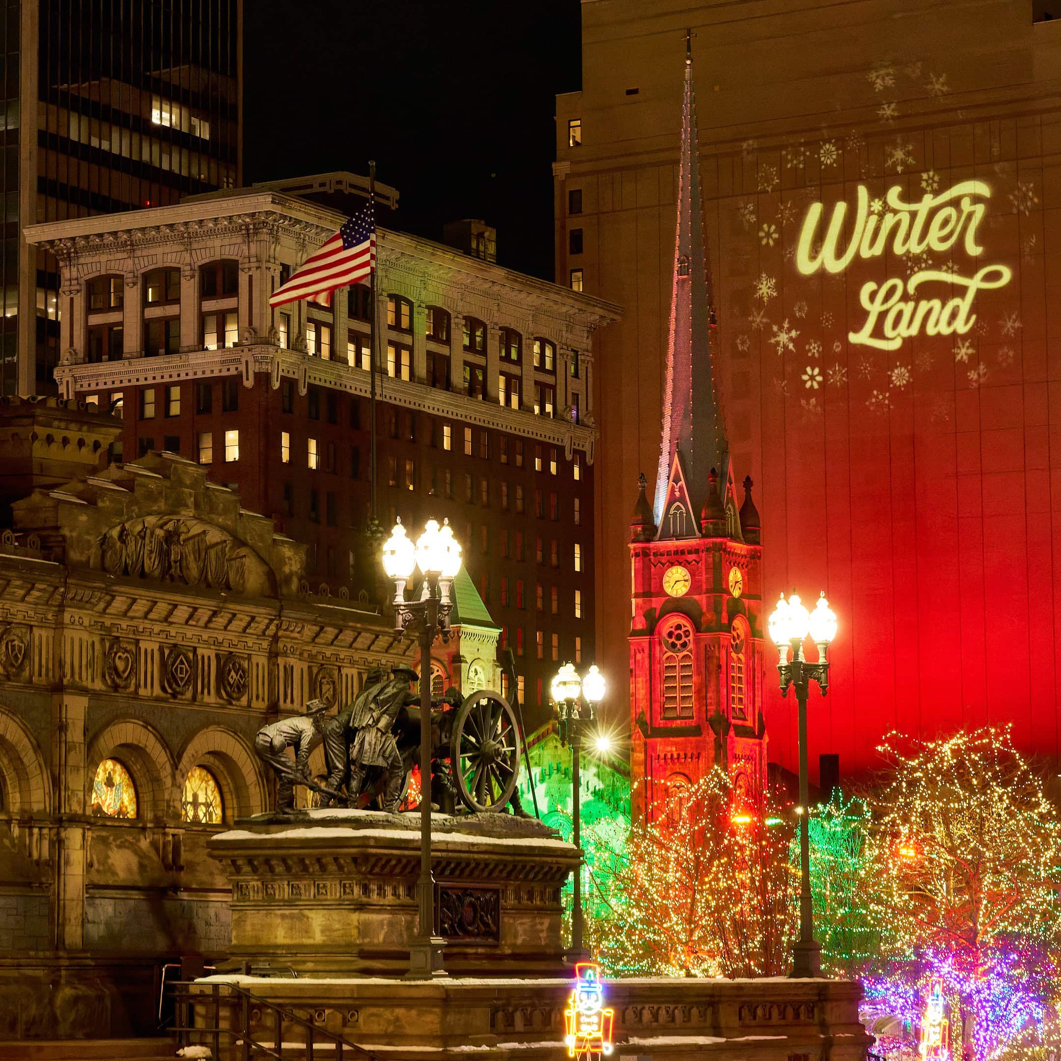 Old Stone Church and Soldiers and Sailors monument lit up with Christmas lights